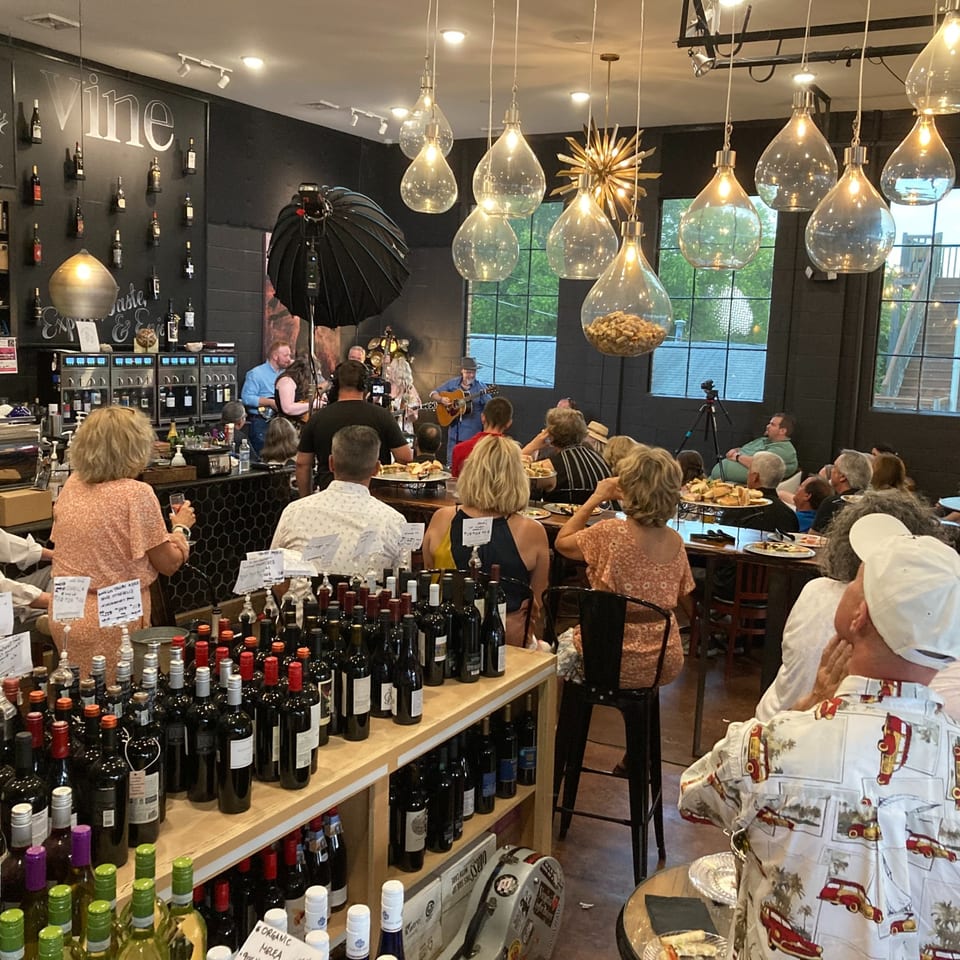 Guests listening to live music inside Crema & Vine.